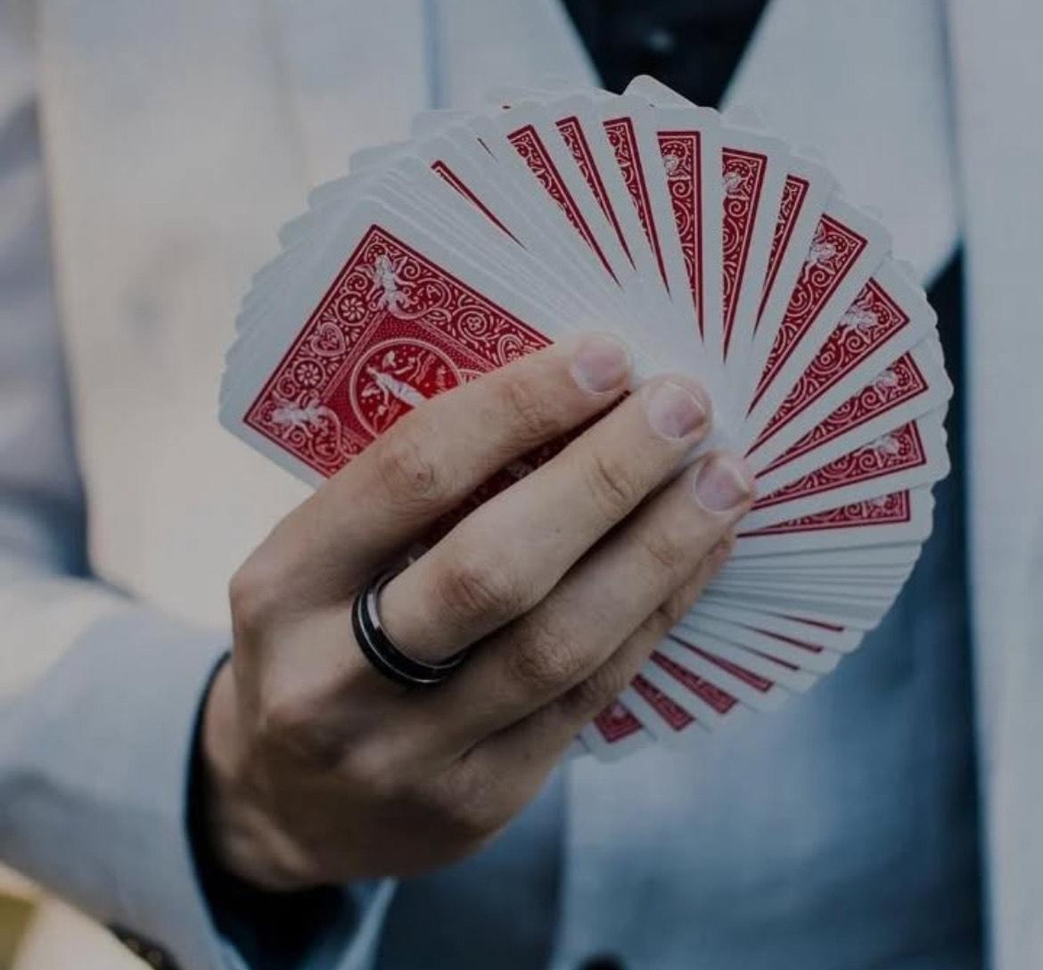 Ollie performing close‑up card magic